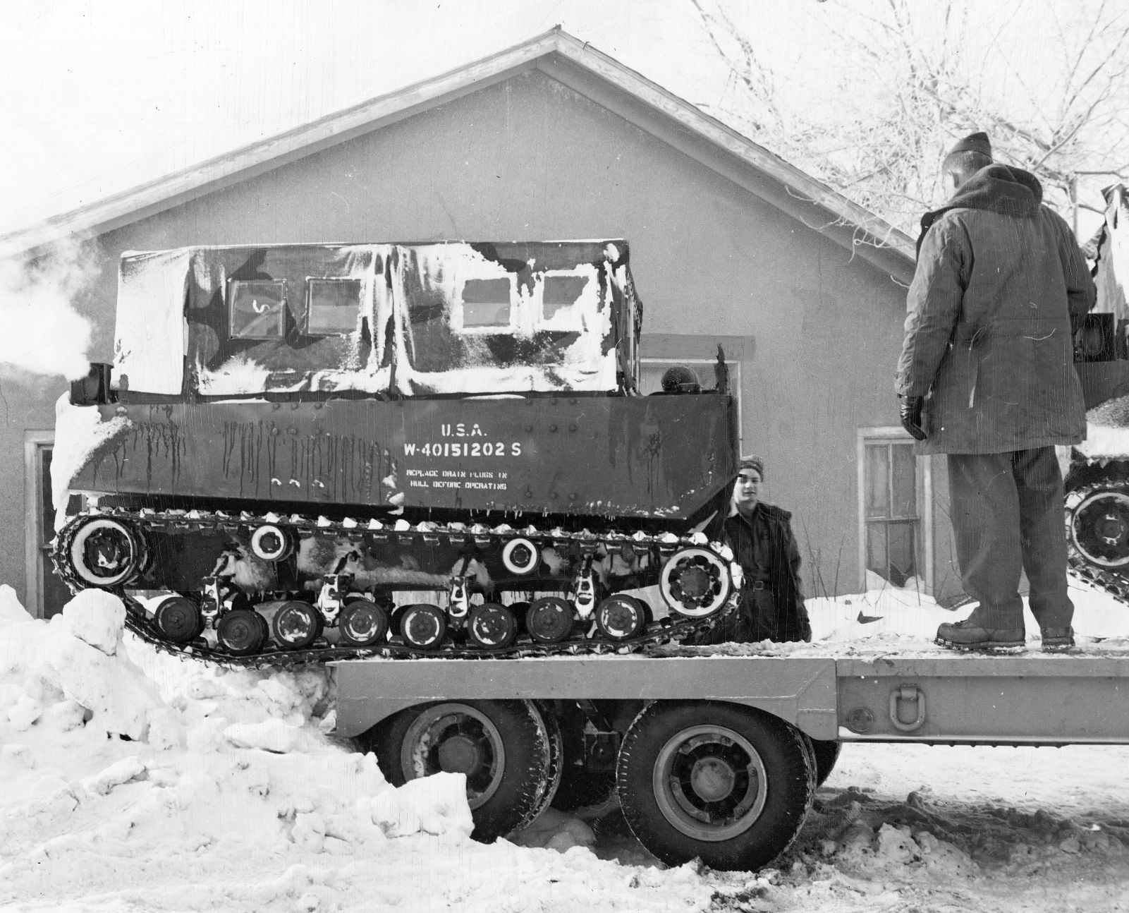 A weasel being loaded at O'Neill for shipment to Creighton, Neb. Published Feb. 5, 1949.